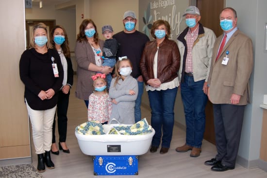 Mary Lou Gamm, Women’s and Children’s Services director; Trish Creach, executive director of Philanthropy; and Kevin McRoberts, FACHE, CEO, accept a CuddleCot in honor of Cohen Michael Isenberg from his mother, Laura; father, Clayton; siblings Bauer, Ruby and Lennon; and grandparents Jane and Leon Heckman.