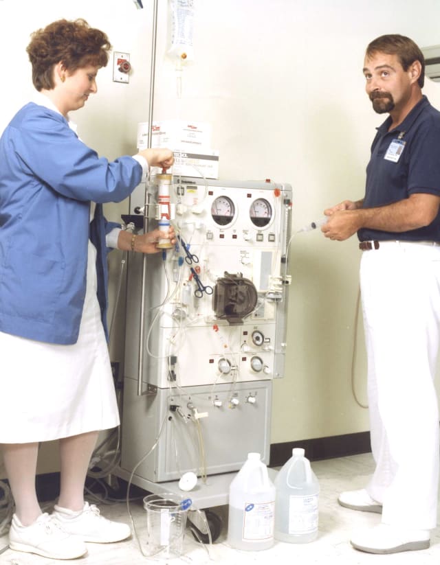 Steve Kivett, right, stands with Carol Zachary, RN, in the Dialysis Department in 1992. The two employees still work together in the Dialysis Department today.