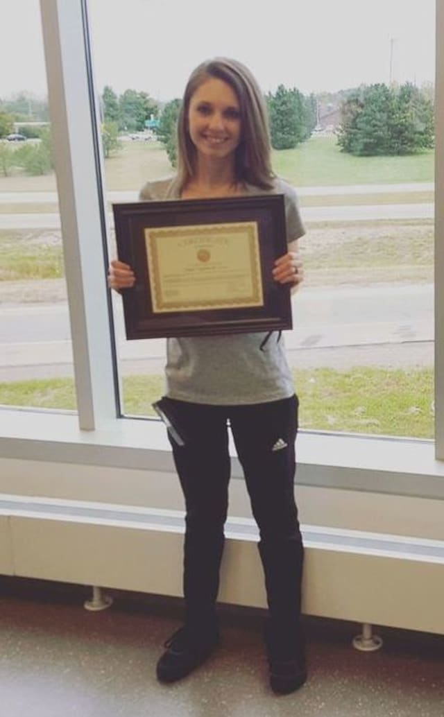 Kayla Englehartdt holding her certificate
