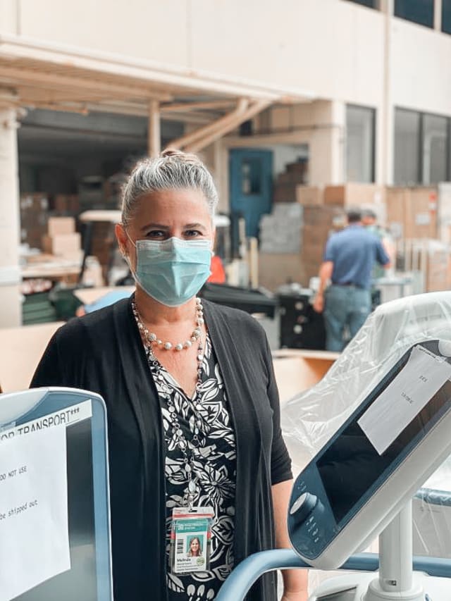 Maui Health Foundation Director Melinda Sweany helps to unpack new ventilators for Maui Memorial Medical Center.