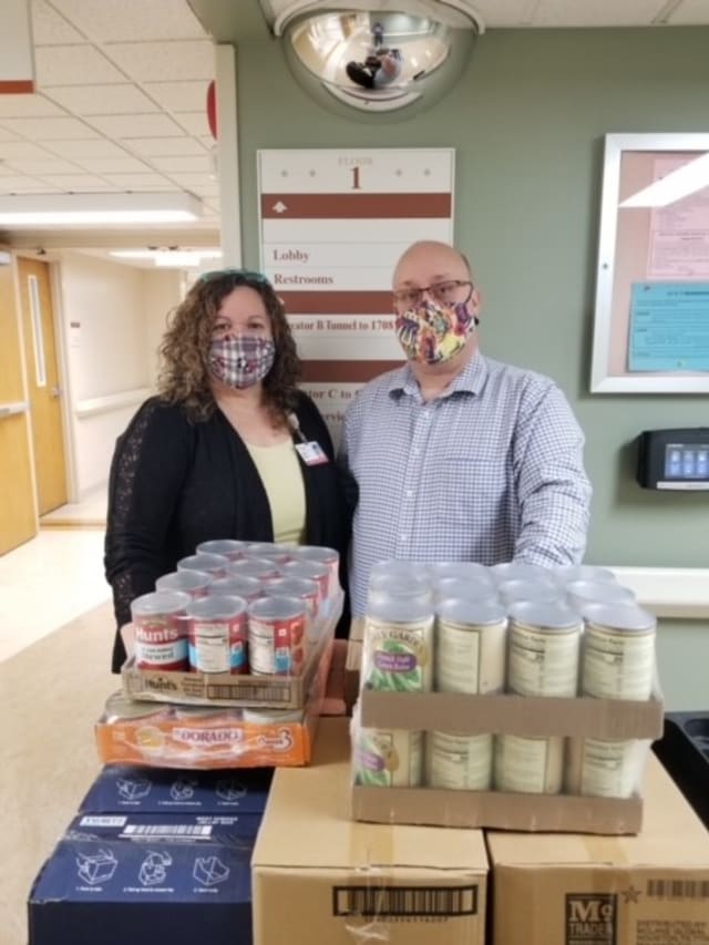 SoutheastHEALTH Clinical Quality Analyst Tonya Meyer and Director of Case Management Dan Ryder with some of the food items in Southeast Hospital’s Patients Pantry, Heroes of Hope program.