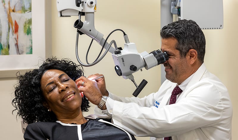 Dr. Nicholas checking on Bernadette.