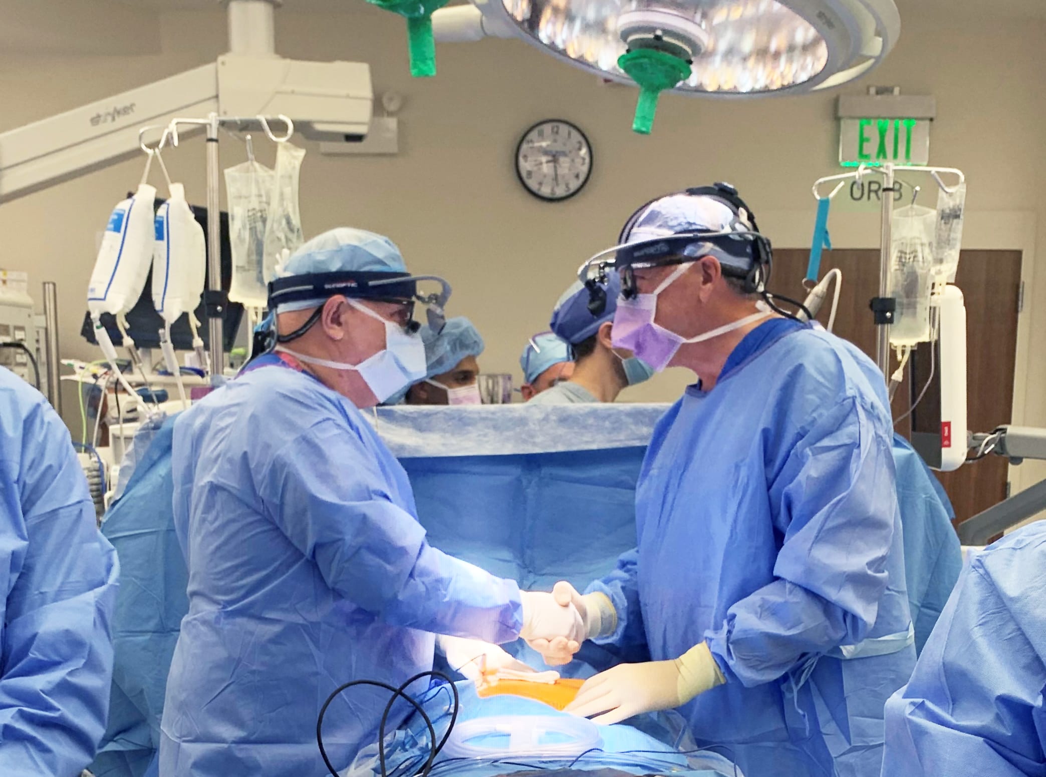 Robert E. Michler, MD, Surgeon-in-Chief, Professor and Chairman, and William A. Jakobleff, Jr. MD, Associate Professor, Department of Cardiothoracic and Vascular Surgery at Montefiore Medical Center/Albert Einstein College of Medicine shake hands prior to starting White Plains Hospital’s first open-heart surgery.