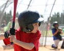 A boy with a baseball bat getting ready for the pitch