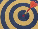 Yellow and blue bullseye with an orange dart in the middle.