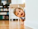  A baby peeks out from around a corner.