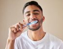 A man brushes his teeth.