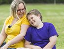 A mom and son sitting together and laughing