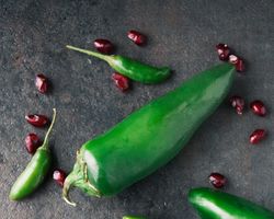 Peppers surrounded by pomegranate.