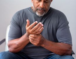 A man massages his own hand