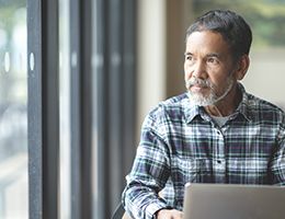 A middle-aged man sitting at a computer.