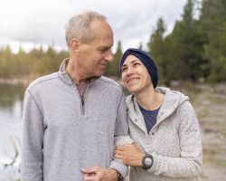 A woman in a head scarf smiles up at a man.