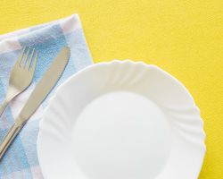 A photo of an empty plate and silverware.