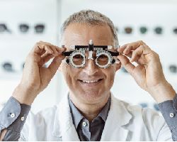 Ophthalmologist holding up a phoropter.
