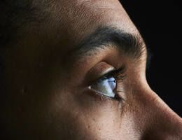 Close-up of a face, focused on an open eye