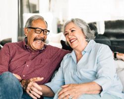 A laughing couple on a couch