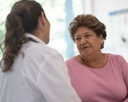 A woman talks to a healthcare provider.