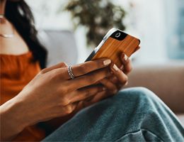 A close-up of a woman's hands holding a smartphone.