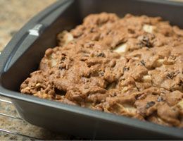 Apple coffee cake in a baking pan, ready to be sliced.