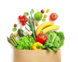 A grocery bag overflowing with fresh produce.
