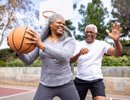  An older couple playing basketball