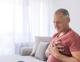 A man clutching his chest over his heart.