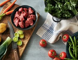 Chunks of beef surrounded by recipe ingredients.