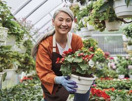 A woman holding a flowerpot