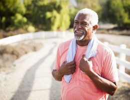  A man holding a towel on his shoulders.