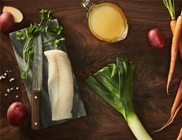 Fillet cod with a leek beside it.