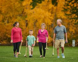  Grandparents and grandchildren walking with croquet mallets