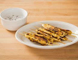 Tandoori chicken skewers with mint raita.