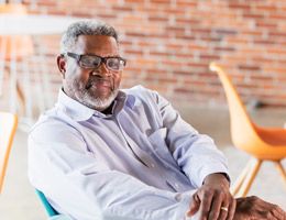 African American man seated in a lunch room or café.