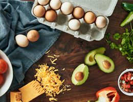 Shredded cheese, sliced avocado and eggs.