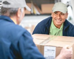 Two men lifting a box