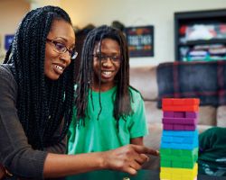 A mother playing an interactive game with her kids.