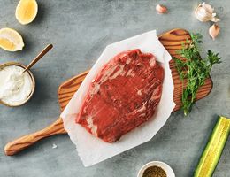 Flank steak on cutting board.