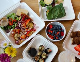 An array of open take-out containers viewed from above.