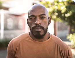 A man in an orange shirt.