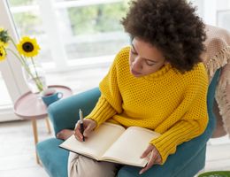 A woman writes in a journal