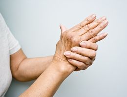 Close up of one hand kneading the other