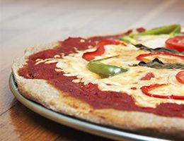 A pizza topped with cheese and peppers.