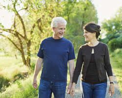  An older man and woman walk together.