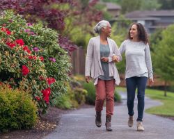 Woman walking beside older woman.