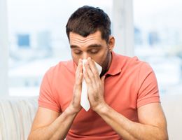 A man blowing his nose.