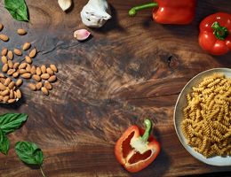 Rotini in a bowl and almonds.