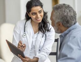  A doctor talking to a an older man.