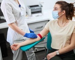 Women sitting, getting ready to have their blood drawn.