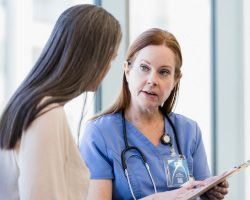 A woman talking to a doctor