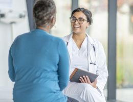 A woman speaking to a medical professional.